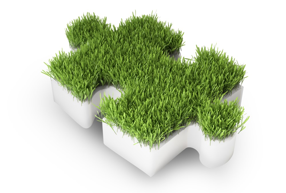 Grass covered puzzle piece - ecology development concept